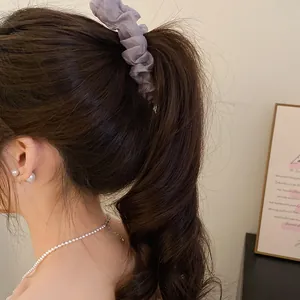 Close-up of lilac ruffled fabric banana clip in a high ponytail hairstyle