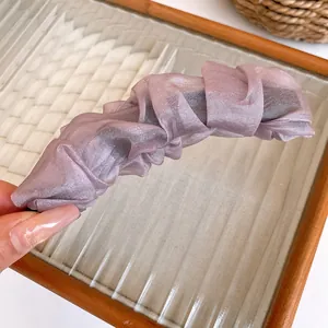 Detail of elegant lavender pleated fabric banana clip designed for high ponytails
