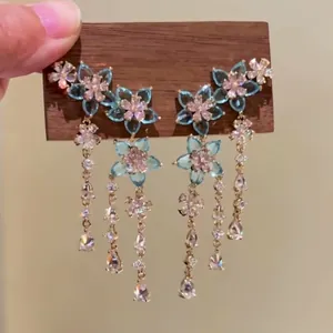 Exquisite close-up of blue zircon flower earrings with elegant long crystal tassels