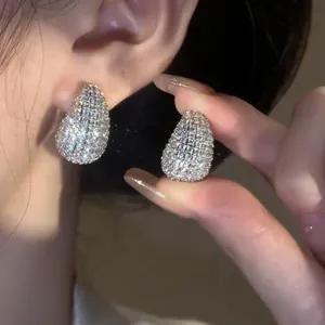 Close-up of elegant teardrop stud earrings encrusted with sparkling cubic zirconia
