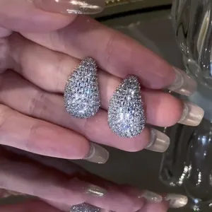 Close-up of elegant teardrop pavé stud earrings with shimmering clear zircons