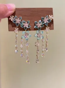Close-up of blue zircon flower tassel earrings with shimmering crystals in vintage style.