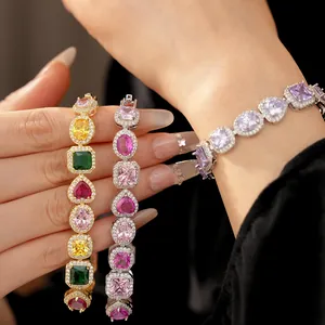 Detailed macro view of colorful zircon heart and oval bracelets worn on a female wrist