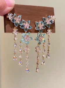 Close-up showing the intricate blue zircon flower motifs and long dangling tassels