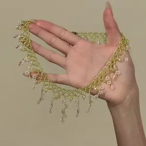 Detail view of a handmade glass beaded fringe necklace with delicate flower patterns.
