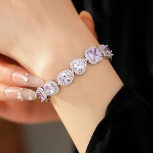 Detailed close-up of a luxury purple zircon bracelet with heart and oval stones on wrist
