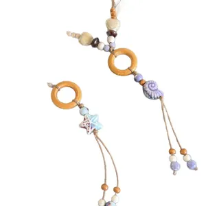 Ethnic style leather cord necklace with wood rings and ceramic starfish shell pendants
