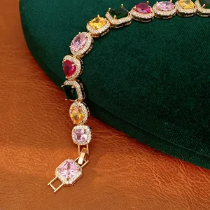 Detailed view of a colorful zircon bracelet featuring heart and oval gemstones in gold setting