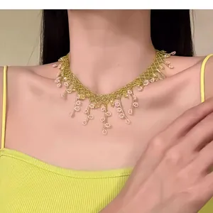 Close-up detail of an elegant handcrafted beaded flower fringe necklace worn by a model
