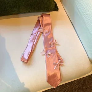 Elegant pink satin necktie necklace with delicate bow details for women