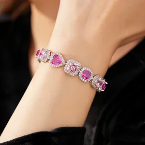 Detailed macro view of elegant purple and pink heart-shaped zircon bracelet on wrist