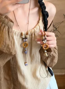 Detailed view of handmade ethnic style necklace with wood rings and ceramic beads