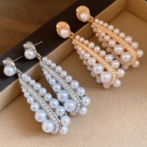 Vintage pearl drop earrings with elegant dangling clusters and gold or silver finish