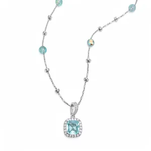 Elegant necklace featuring a square light blue stone with a zircon halo and glass beads