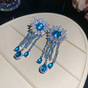 Macro view of blue zircon flower tassel earrings with sparkling teardrop details