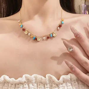 Close-up view of a colorful beaded necklace featuring gold flower pendants and white pearls