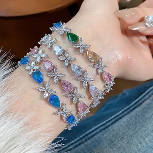 Detail view of multicolored zircon bracelets with teardrop and flower design on wrist