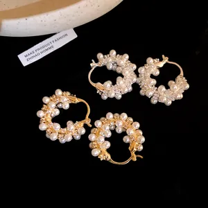 Detailed view of 18K gold plated hoop earrings with pearls and cubic zirconia stones