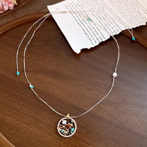 Bohemian necklace with circular stone beaded pendant on a rustic wooden background