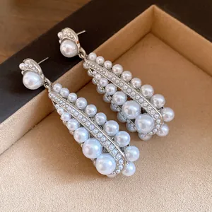 Elegant vintage silver needle earrings featuring clustered round pearl teardrop pendants