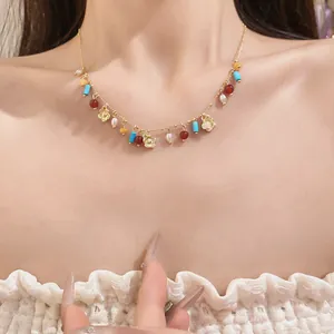Close-up of beaded necklace with hollow flower pendants and colorful stones