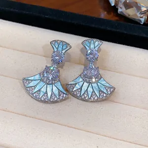 Elegant fan-shaped earrings with light blue enamel and sparkling cubic zirconia stones
