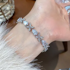 Close-up of elegant silver bracelet with sparkling zircon drop and floral designs