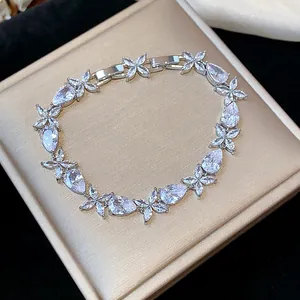 Detail of silver-toned bracelet featuring sparkling zircon flower and teardrop motifs