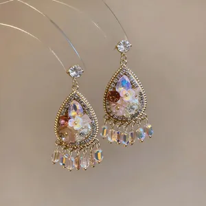 Close-up detail of French vintage teardrop floral earrings with crystals and silver needle