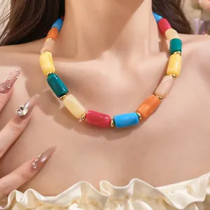 Detail view of colorful marbled cylindrical acrylic beads dopamine necklace on neck