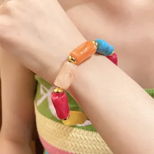 Detailed shot of a colorful dopamine style acrylic marbled cylindrical bead bracelet worn on wrist