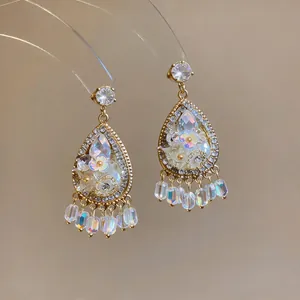 Detailed view of French palace style teardrop earrings with floral motifs