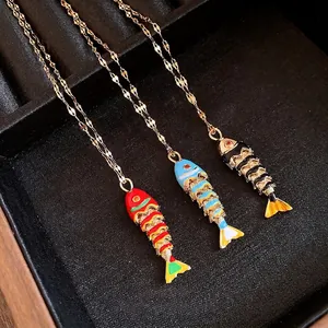 Elegant stainless steel enamel fish pendant necklaces available in red, blue, and black.