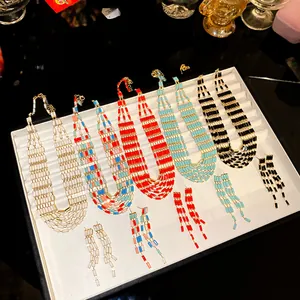 Detailed view of bohemian style rectangular beaded necklace and earring sets in varied colors.