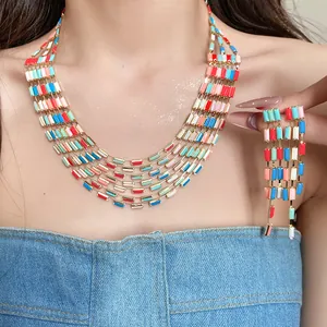 Detailed view of vibrant multi-layered rectangular jewelry set worn on model's neck