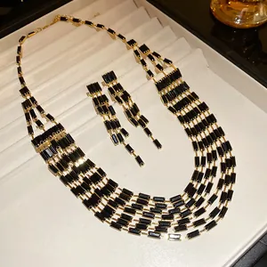 Close-up of vintage multi-layer necklace and earring set with black rectangular crystals