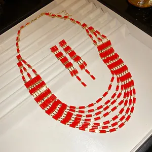 Detail of vintage palace style multi-layer red rectangle bib necklace and earring set