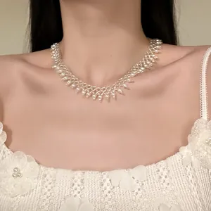 Detailed macro view of an elegant French design white pearl beaded fringe choker necklace