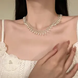 Detailed close-up of an elegant French design pearl beaded lace choker necklace on a model