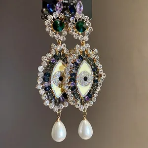 Elegant vintage rhinestone eye drop earrings with shimmering white water drop pearls