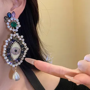 Vintage evil eye statement earrings featuring multi-colored rhinestones and a pearl drop