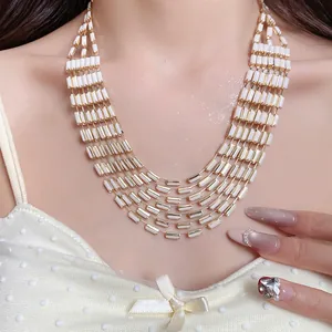 Detailed close-up of retro court style multi-layer necklace with white rectangular beads