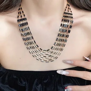 Close-up detail view of vintage style multi-layer necklace with black rectangular beads