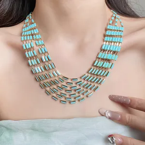 Detailed view of a vintage five-strand turquoise necklace with gold rectangular beads.