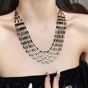 Detailed view of a retro palace style multi-strand necklace with black rectangular beads