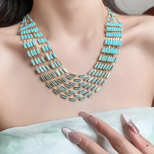 Detailed view of a vintage court style multi-layer necklace with light blue rectangular beads