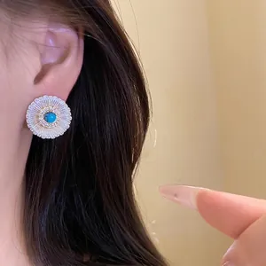Vintage inspired round stud earrings featuring a turquoise stone and zircon halo
