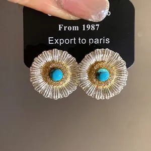 Vintage sunburst stud earrings with central turquoise stone and zircon accents