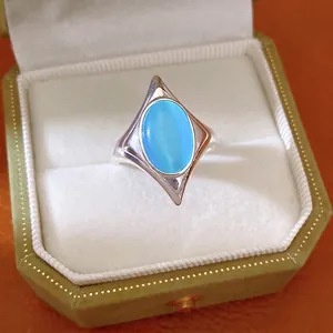 Elegant silver open ring featuring a blue oval cat's eye stone in a star-shaped setting