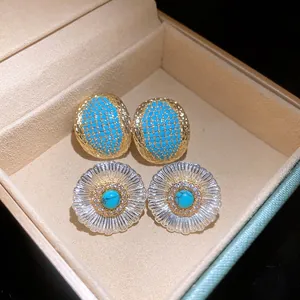 Exquisite detail of vintage turquoise stud earrings featuring zircon accents and silver pins
